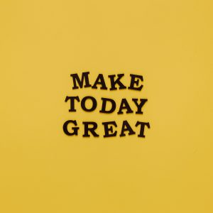 Simple and motivational quote 'Make Today Great' on a minimalist yellow background for inspiration.